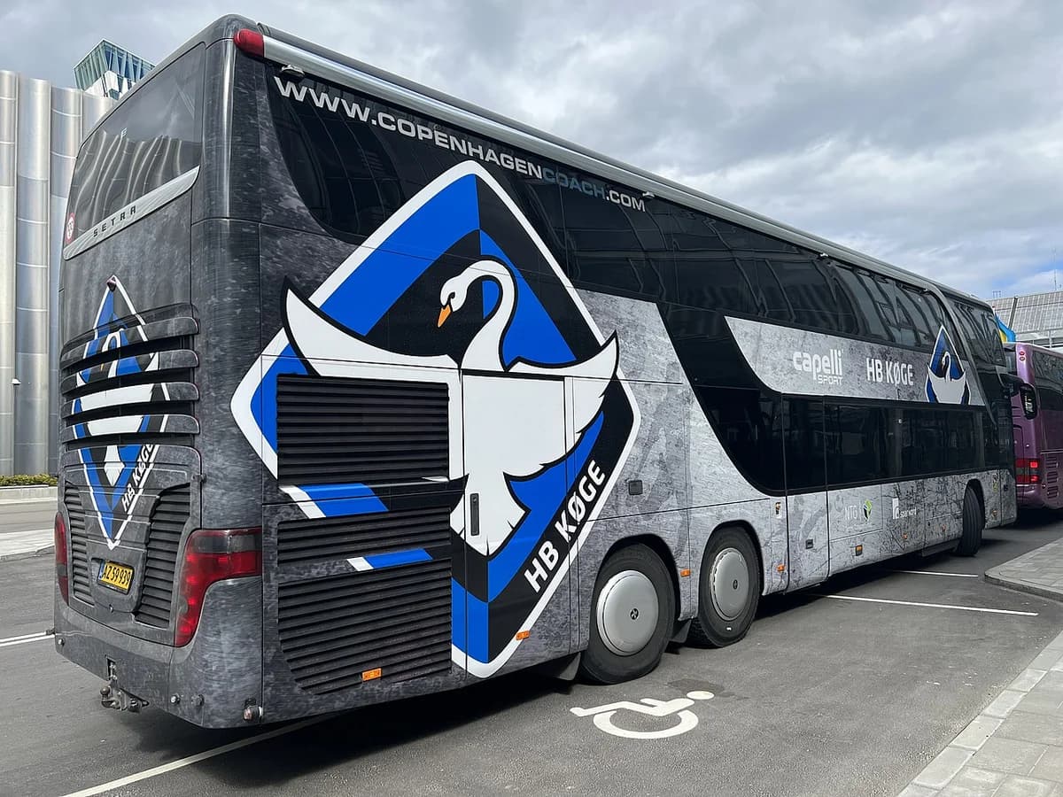Rear of HB Køge team bus with logo and sponsors