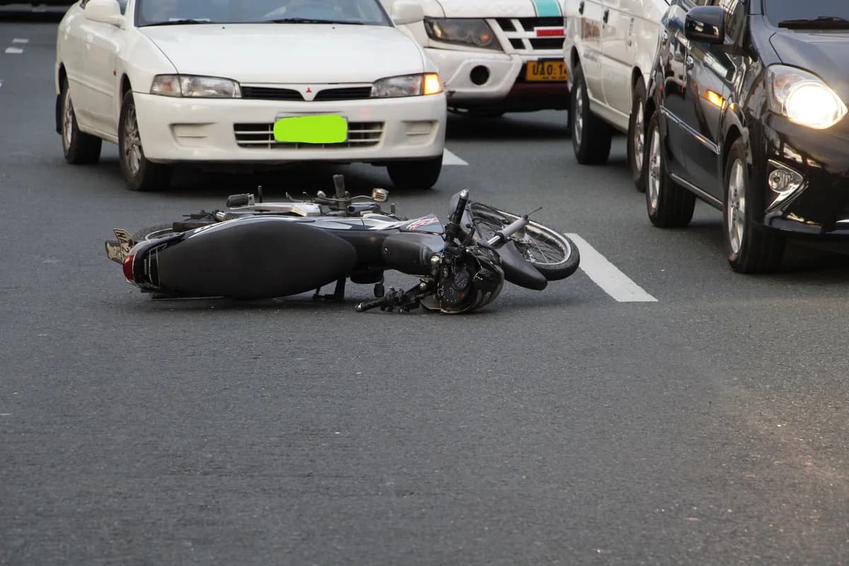 Motorcycle lying on city road after accident