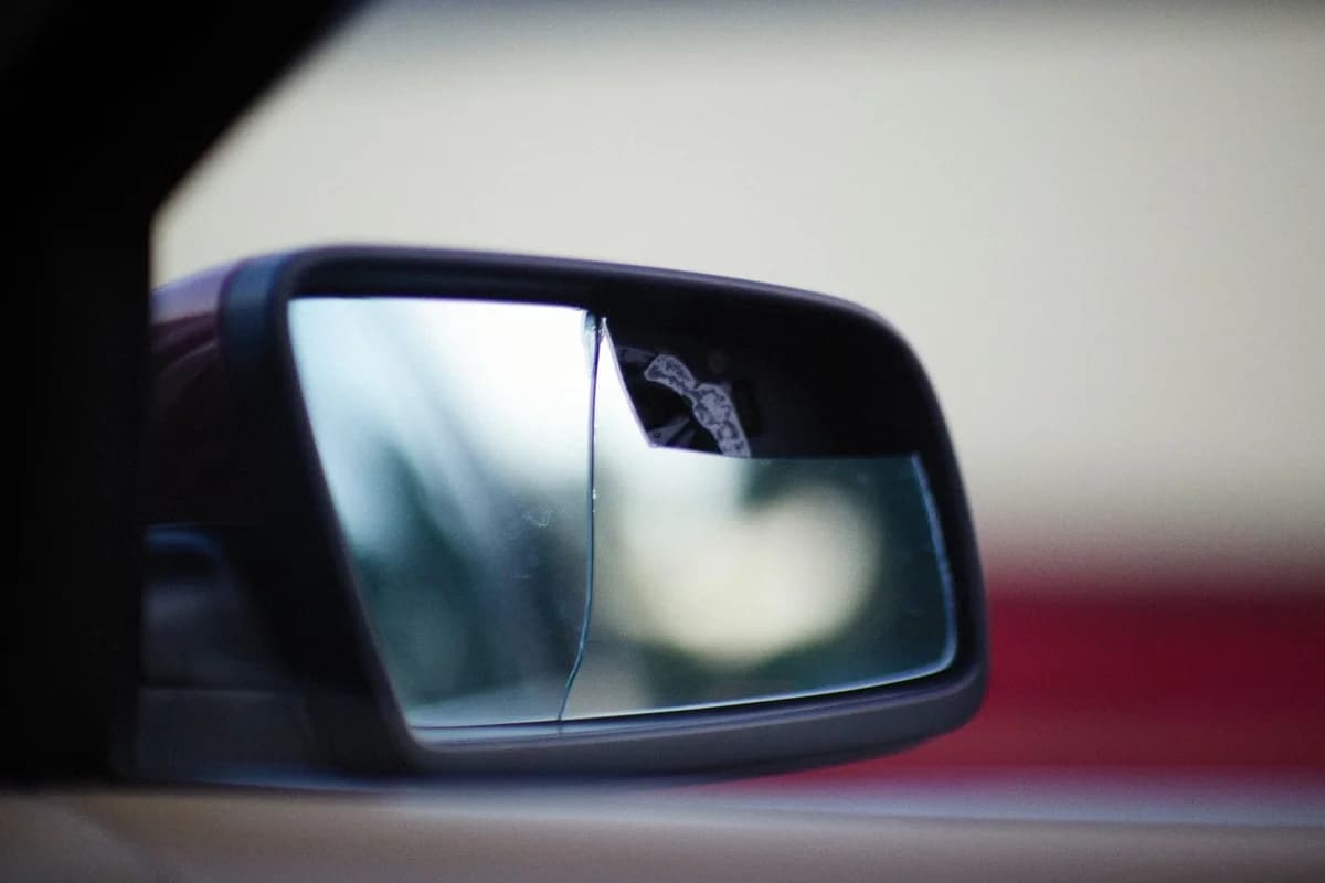 Close-up of a broken car side mirror.