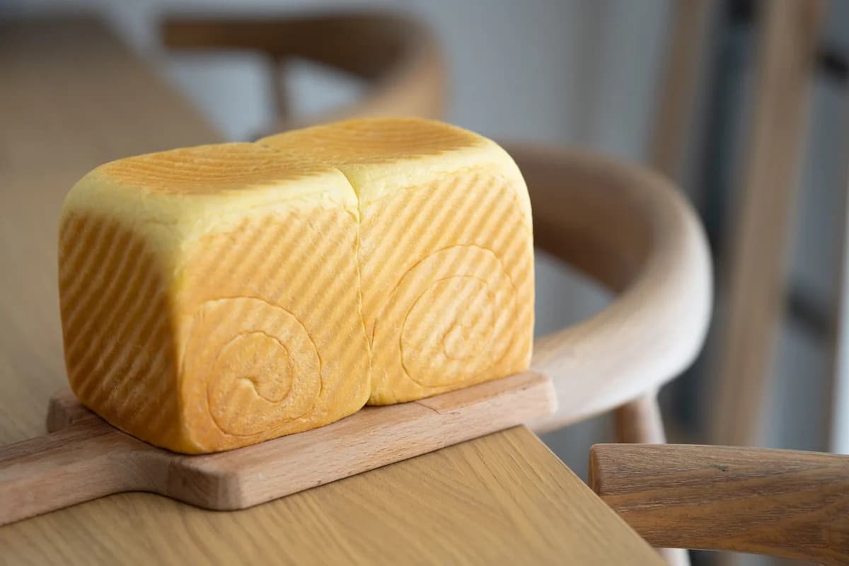 Close-up of a loaf of artisan bread on a wooden board.