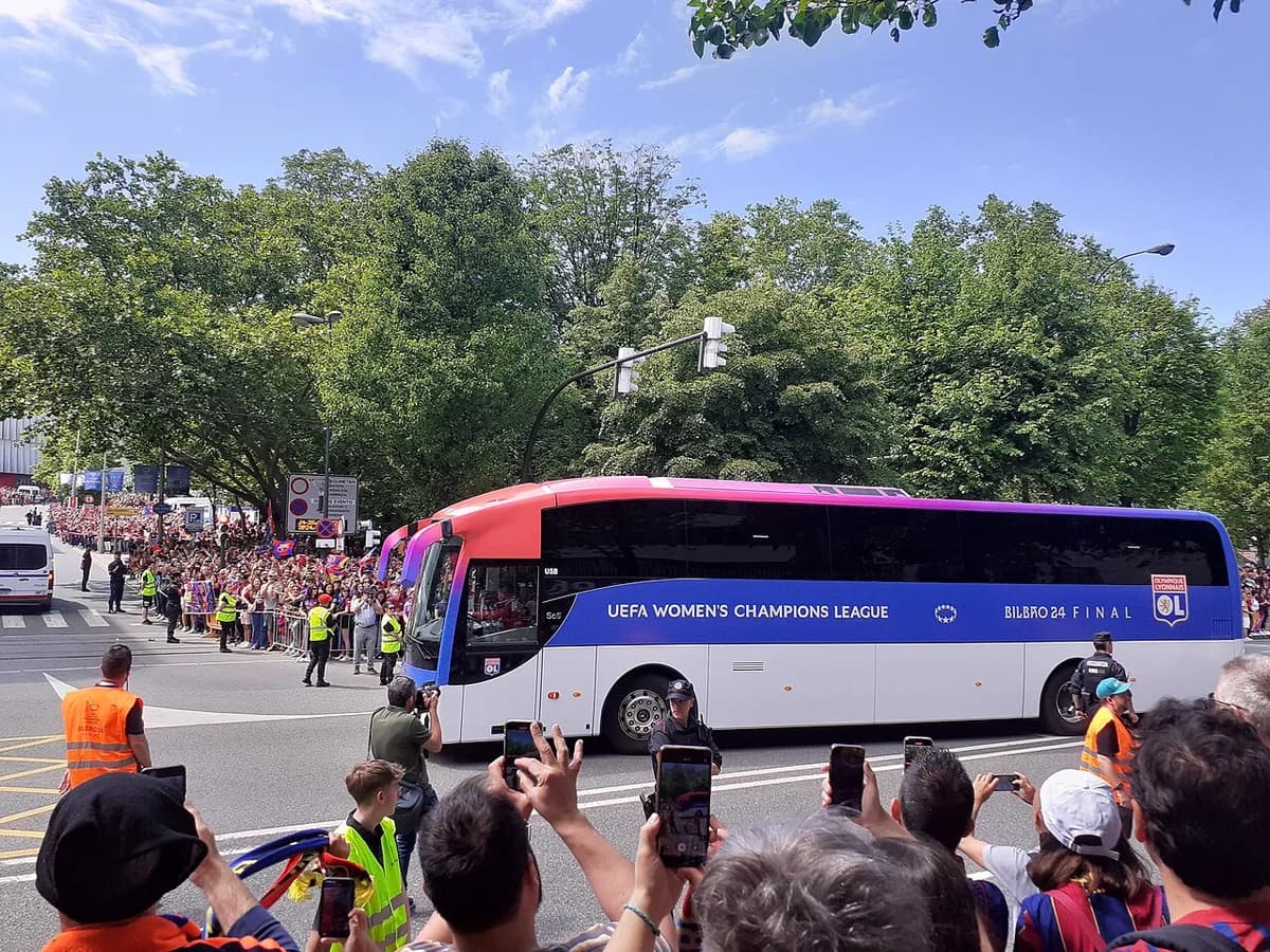 A women’s team bus passes a cheering crowd at the 2024 UEFA Women’s Champions League final.