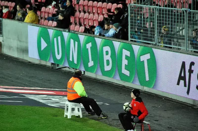 Steward and ball boy at football stadium edge